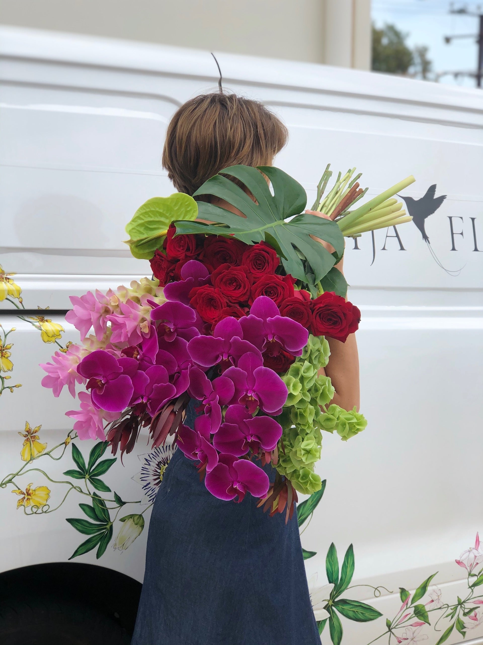 maria carrying a large bouquet of flowers valentine's day order