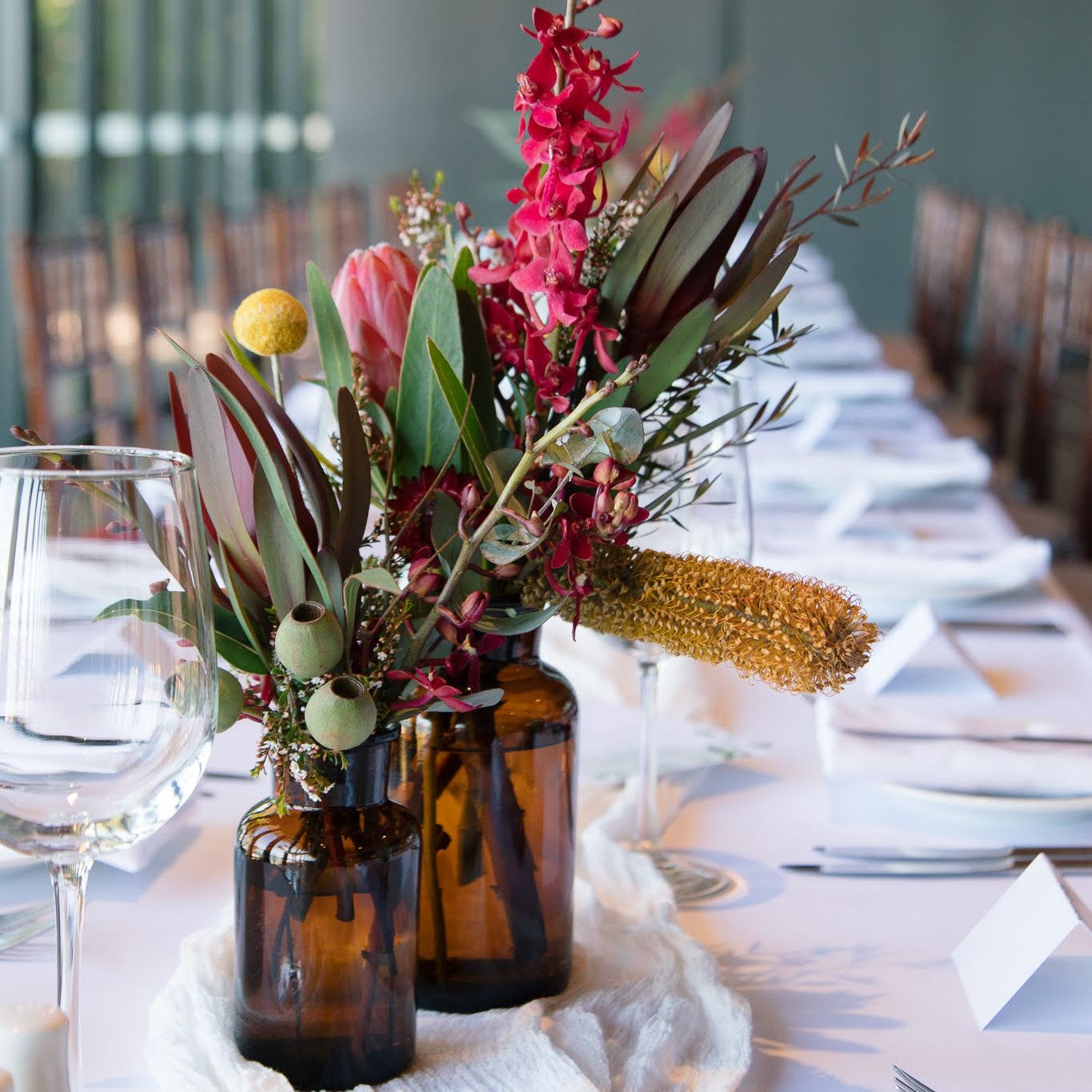 Beija Flor Table Centrepieces Native Flowers with Amber Specimen Bottle at Pee Wees - Darwin Wedding