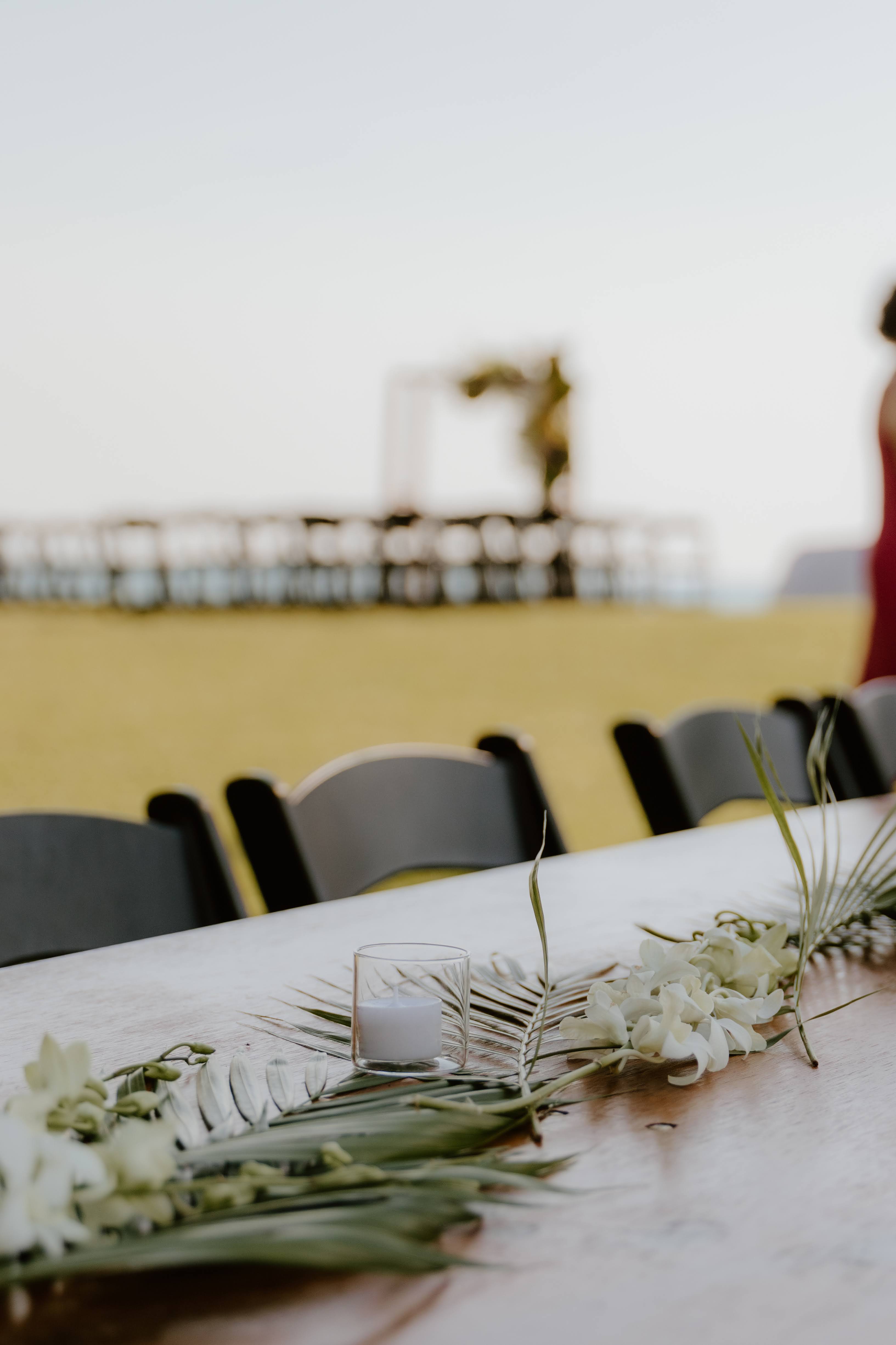 Tropical flat lay flowers with tea lights for a beachside Darwin wedding