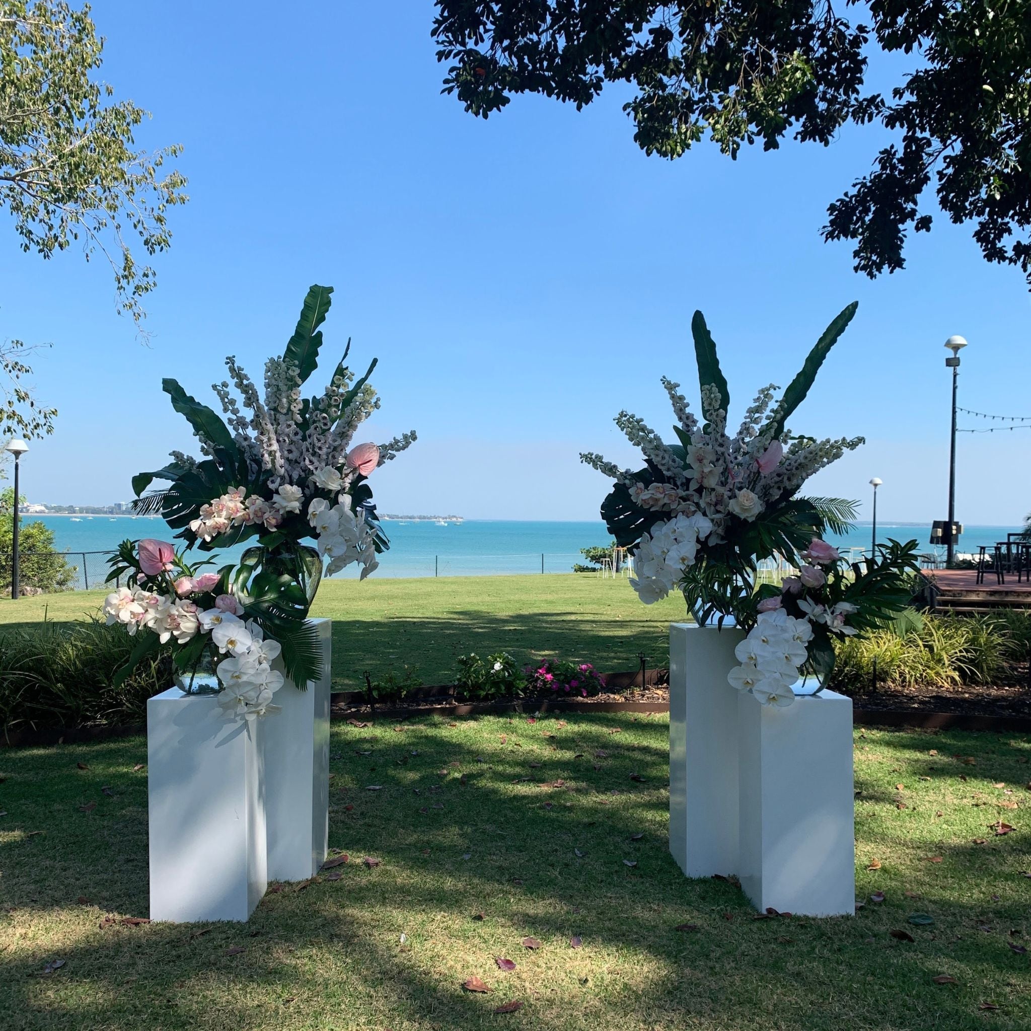 plinth florals for a Darwin wedding ceremony with luxe flowers like phalenopsis orchids and delphinium overlooking the water at Pee Wees at the Point