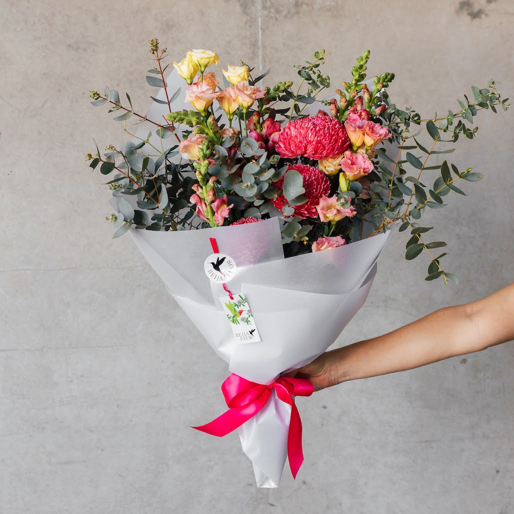 Bright pink blooms wrapped in white paper