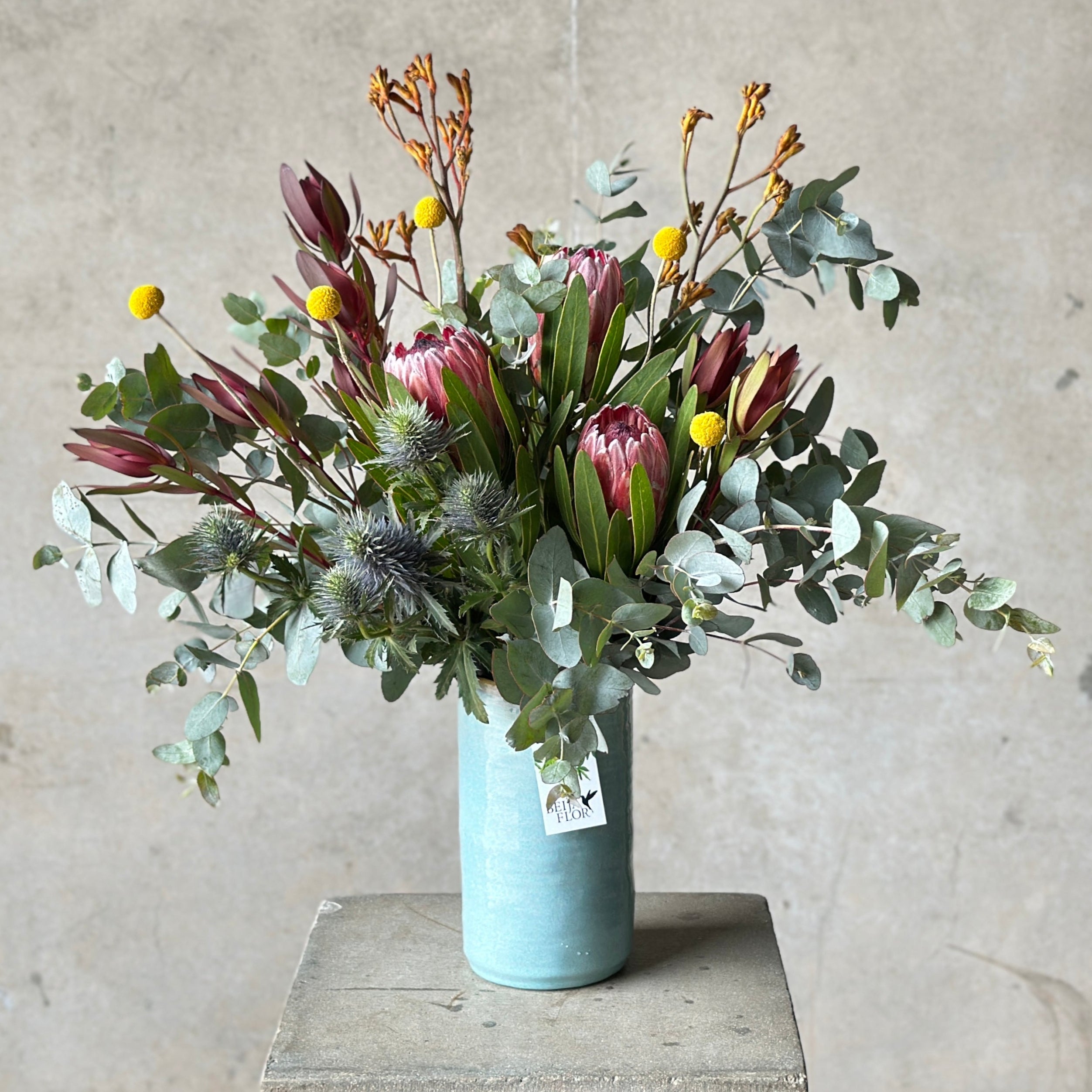 marrakech native vase arrangement in pale blue glazed vase