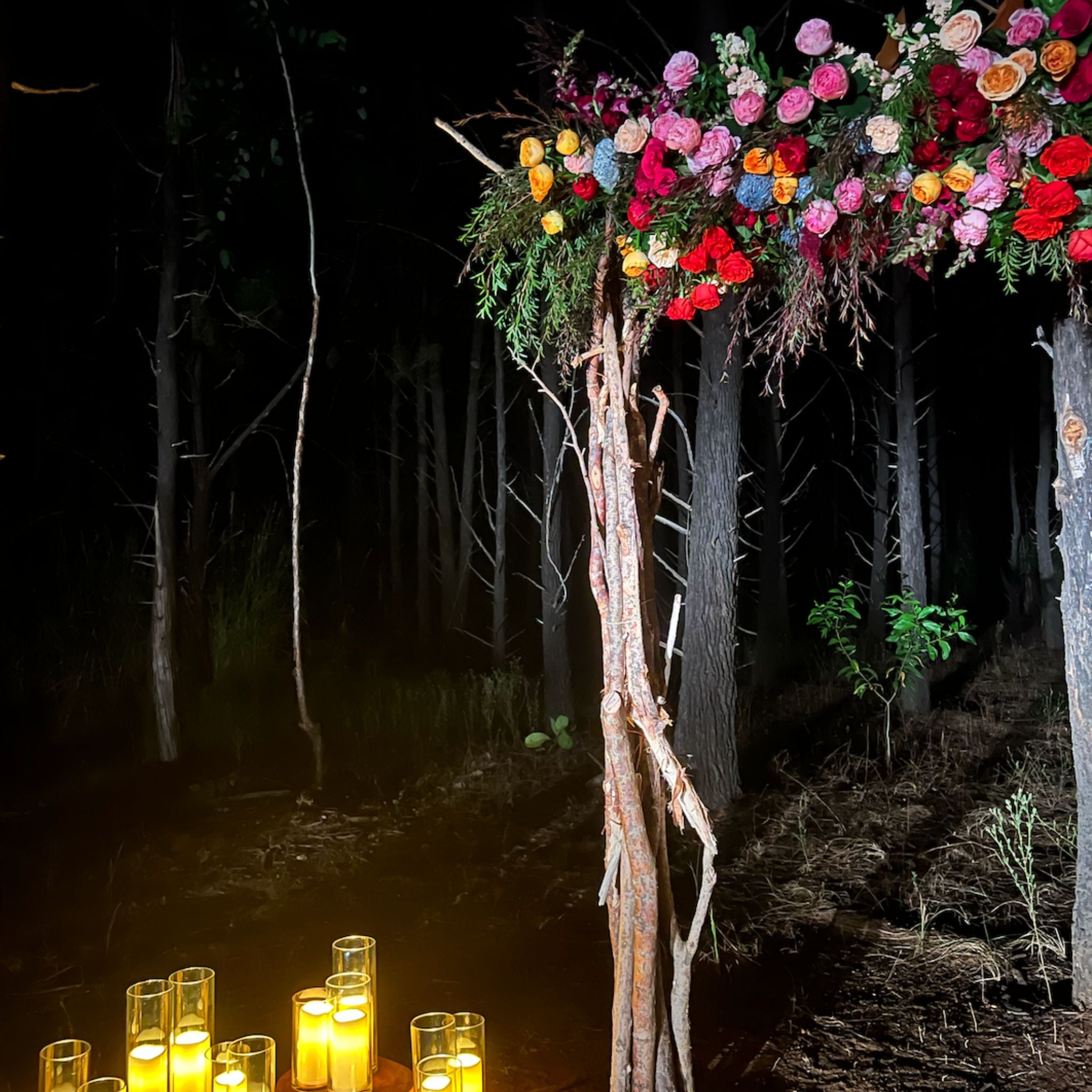 Beija Flor Darwin - Hire and Prop Items - Night woodland wedding arch with colourful flowers and glowing candles