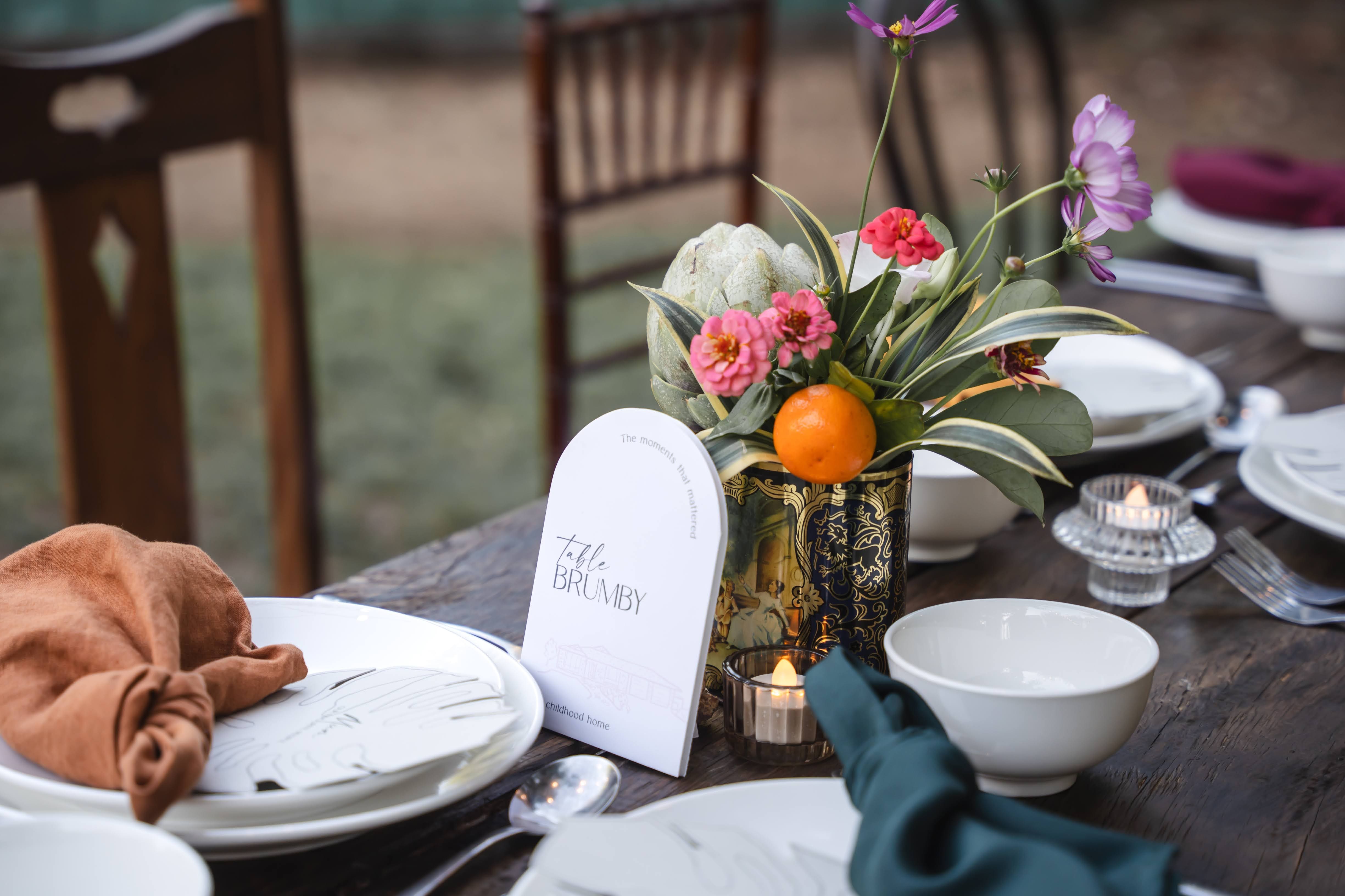 Kayla and Russell Beija Flor Real Wedding Reception table with tropical flowers in vintage tin