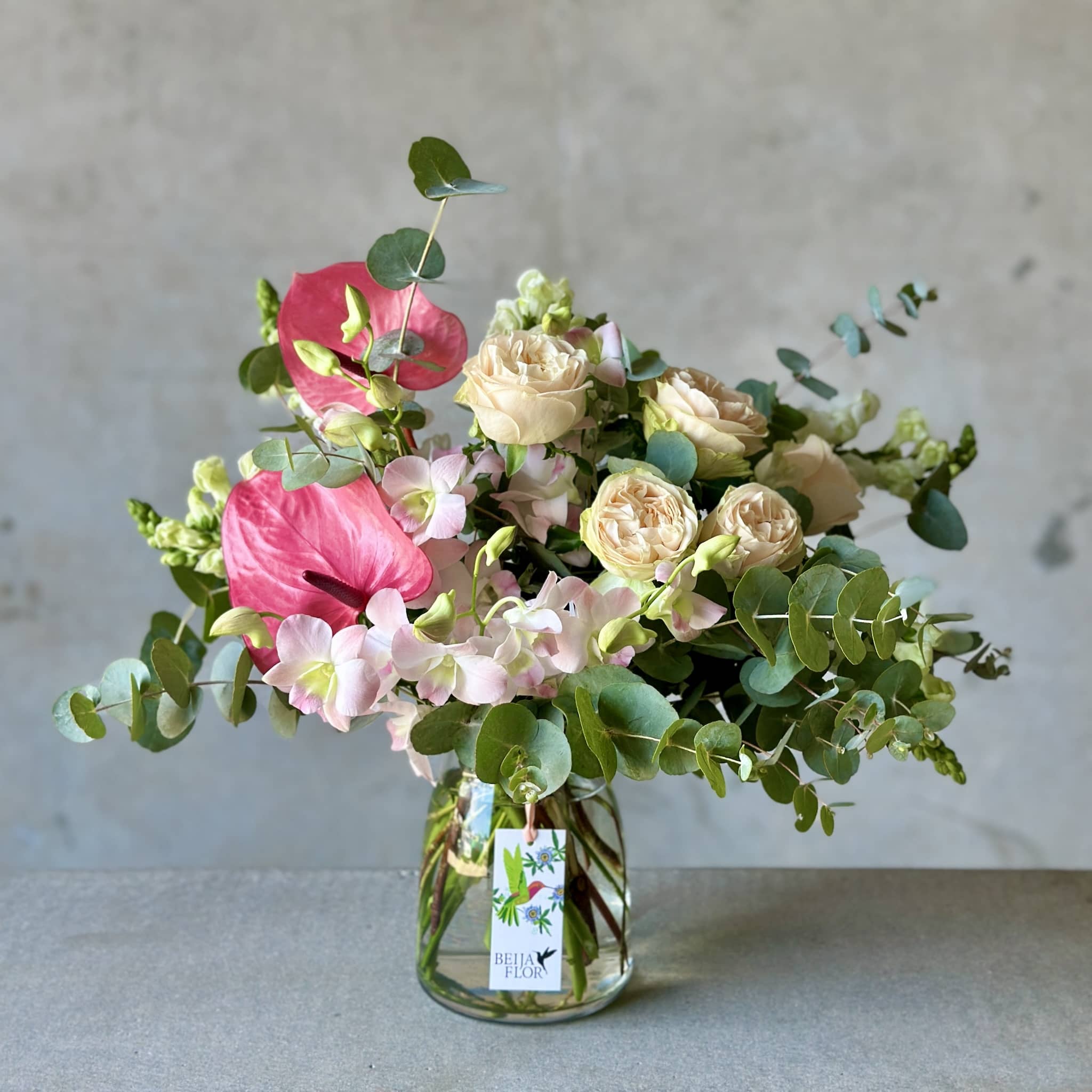 vase of flowers in peach and pink shades