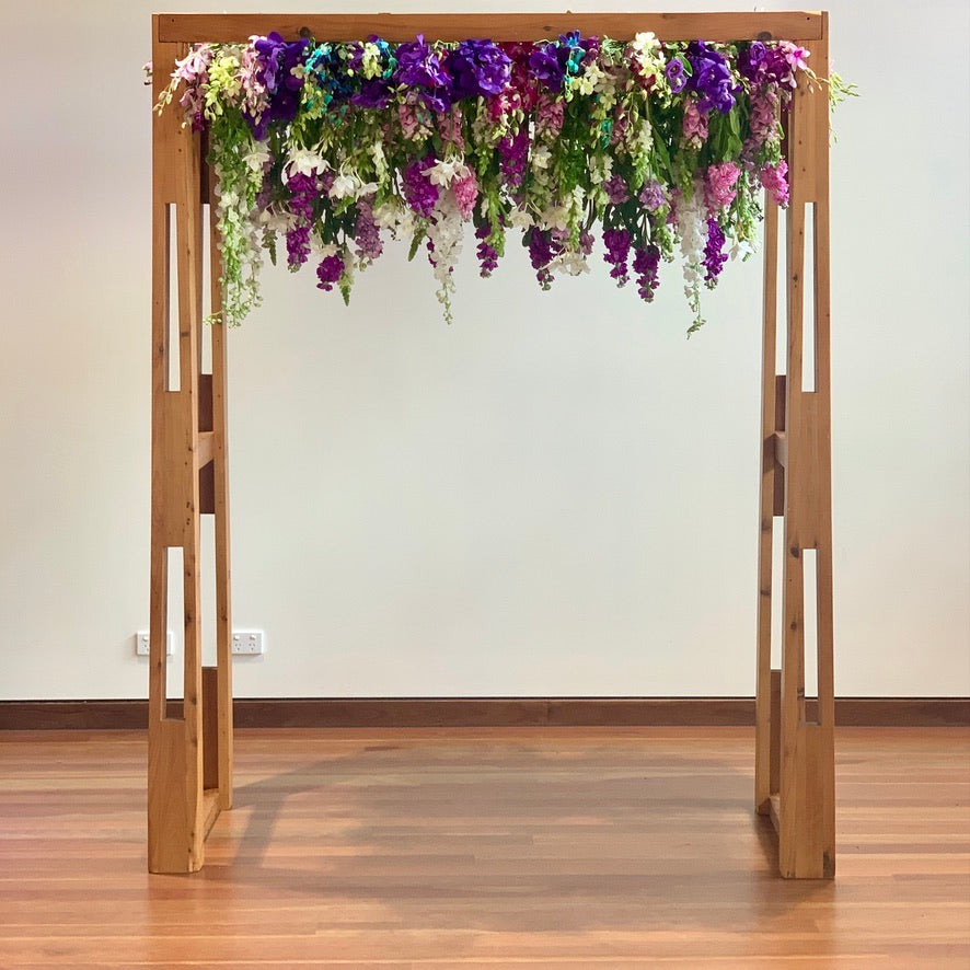 Timber Arbour clad with purple cascading flowers by Darwin florist Beija Flor