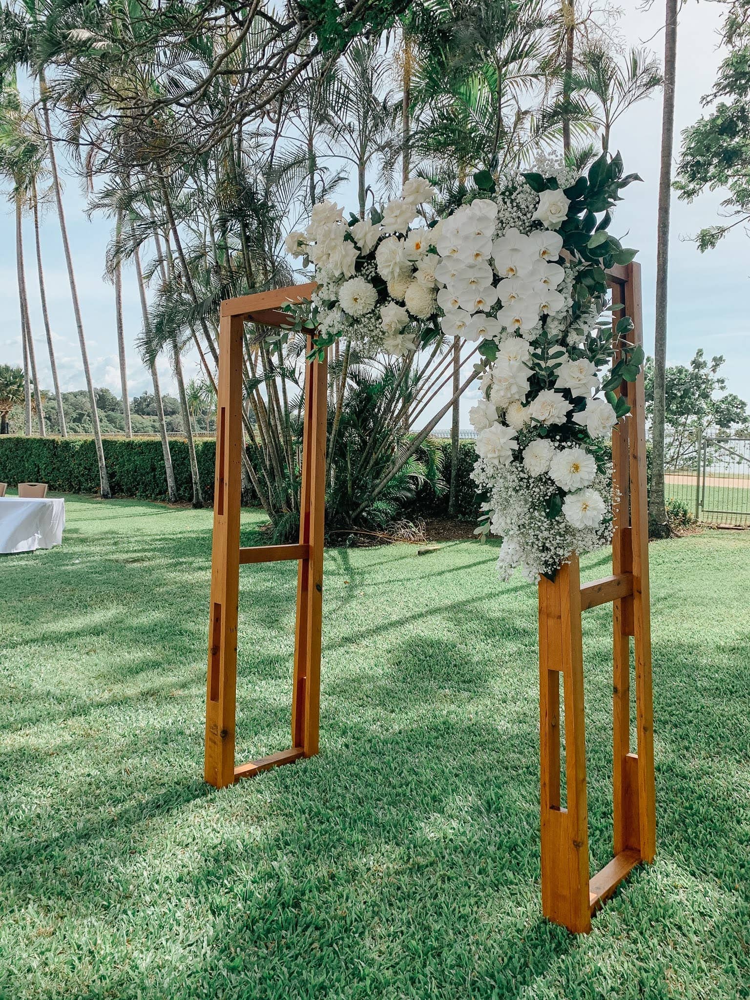 Timber Arbour dressed in lush white flowers on the lawns at Mindil Beach Casino Darwin florist Beija Flor