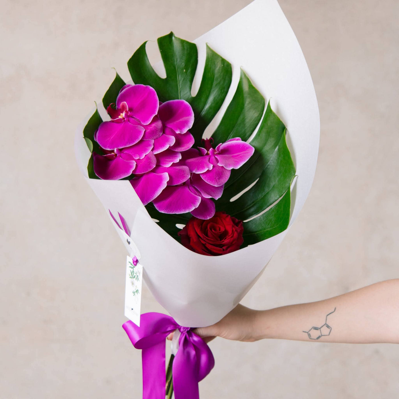 Simple bouquet of cerise orchids and red rose